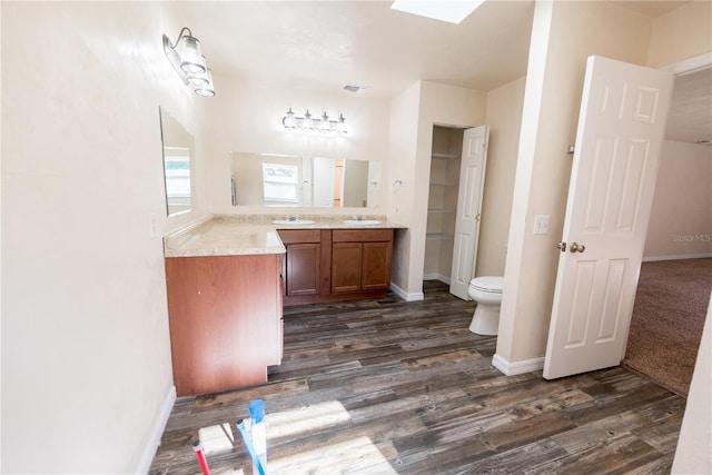 bathroom featuring vanity, toilet, and wood-type flooring