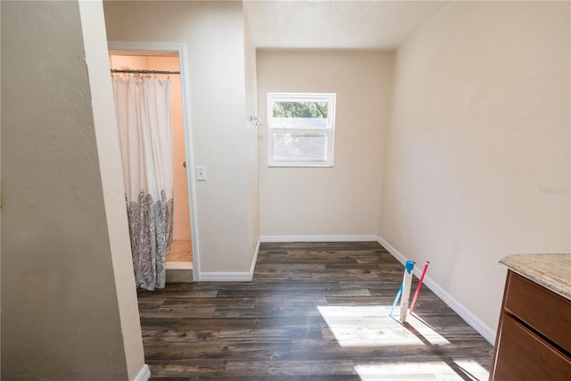 unfurnished bedroom with dark hardwood / wood-style floors