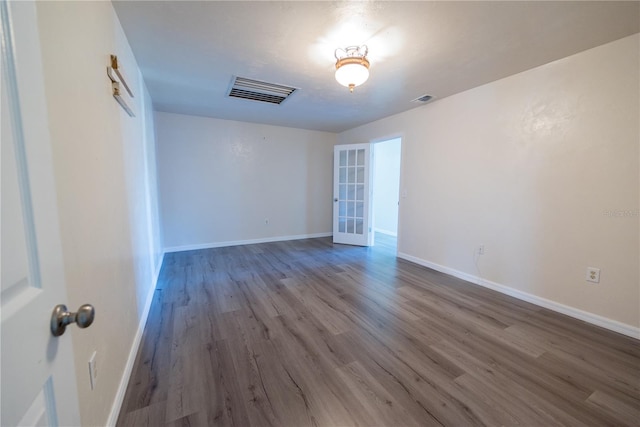 empty room with french doors and hardwood / wood-style floors