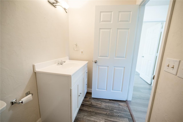 bathroom with hardwood / wood-style floors and vanity