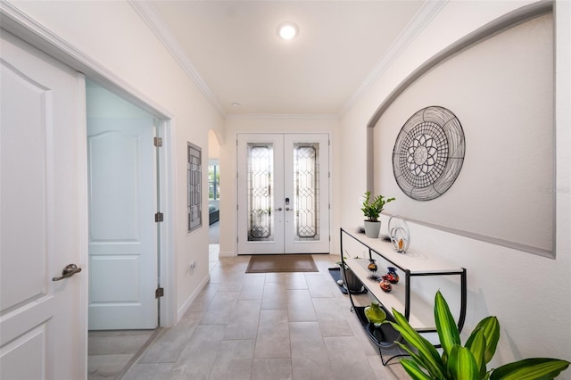 foyer with ornamental molding and french doors