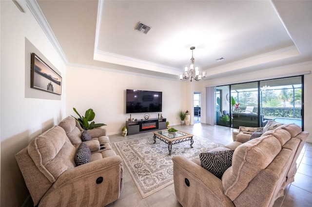 living room with ornamental molding, an inviting chandelier, light tile patterned flooring, and a tray ceiling