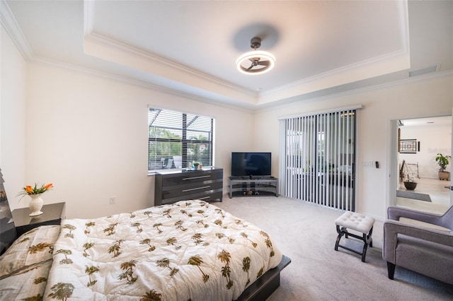 bedroom featuring a raised ceiling, carpet floors, and ornamental molding