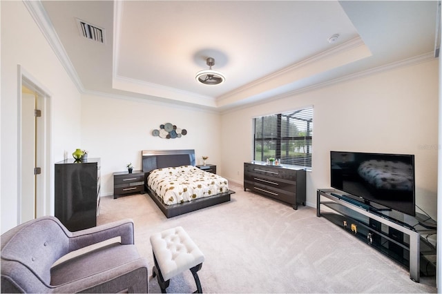 bedroom featuring light carpet, a tray ceiling, and ornamental molding