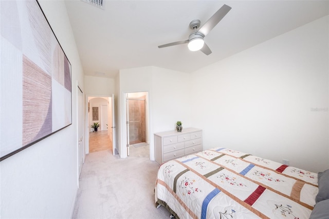 carpeted bedroom with ceiling fan and connected bathroom