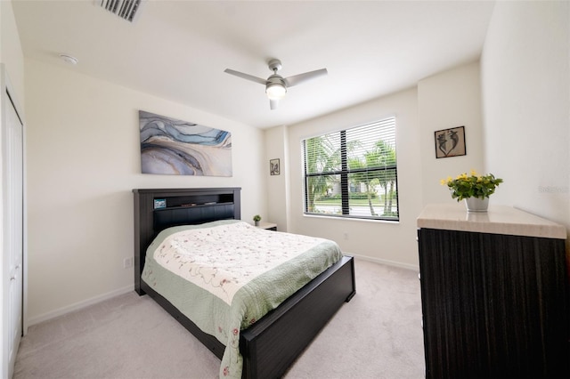 carpeted bedroom featuring ceiling fan and a closet