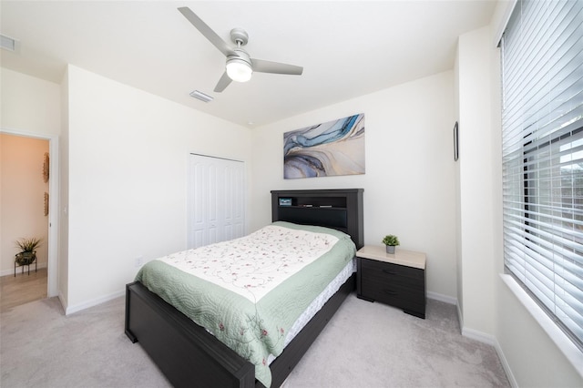 carpeted bedroom with a closet and ceiling fan