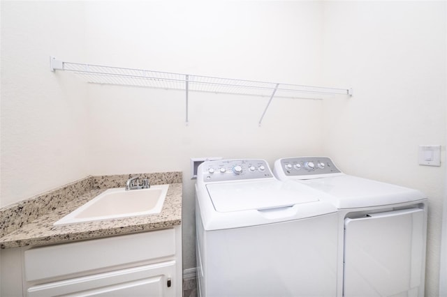 washroom with sink and independent washer and dryer