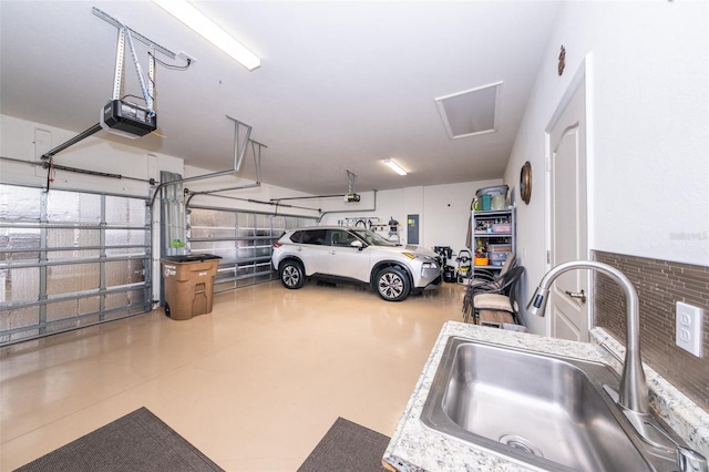 garage with sink, electric panel, and a garage door opener