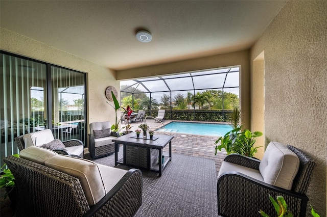 view of pool featuring glass enclosure, a patio area, and an outdoor living space