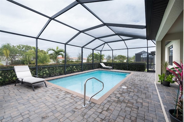 view of pool featuring a lanai and a patio