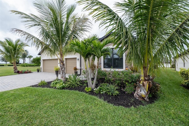 view of front facade with a front yard and a garage