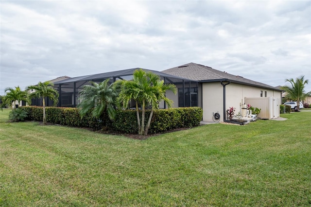 view of home's exterior with a lanai and a lawn