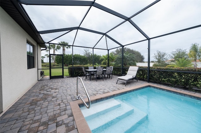 view of swimming pool with a lanai and a patio