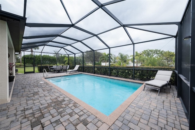 view of swimming pool with a lanai and a patio