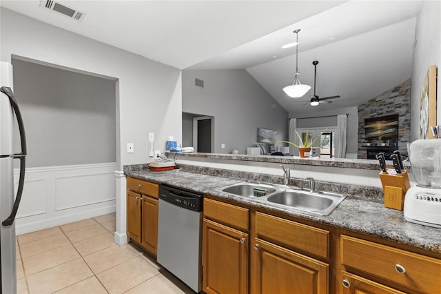 kitchen featuring vaulted ceiling, appliances with stainless steel finishes, sink, light tile patterned floors, and ceiling fan