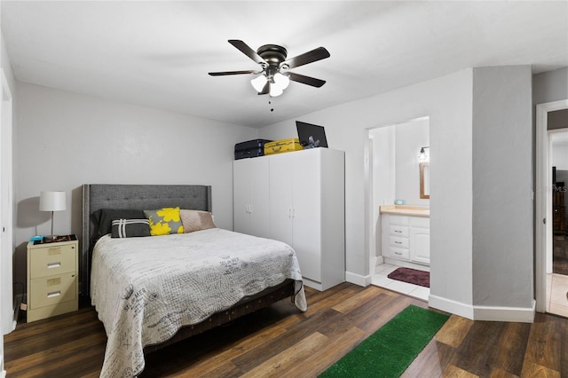 bedroom featuring ensuite bathroom, dark hardwood / wood-style floors, and ceiling fan