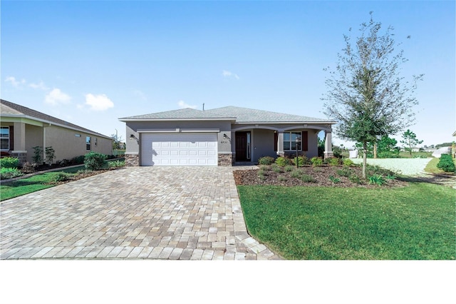 view of front of home with a front yard and a garage