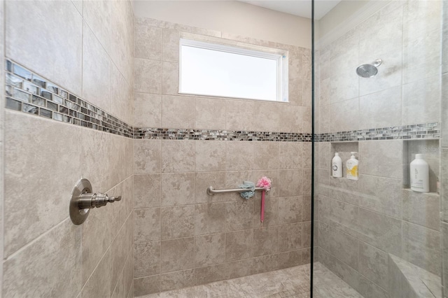 bathroom with a tile shower