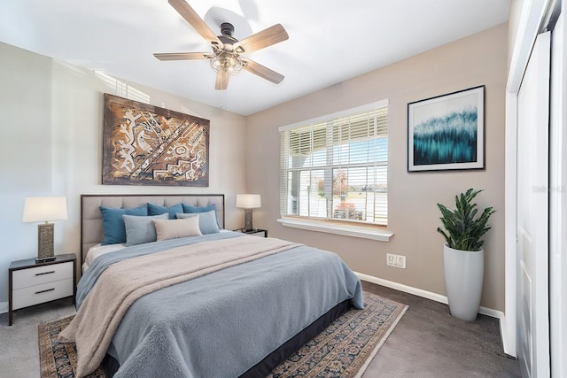 bedroom featuring ceiling fan, a closet, and dark colored carpet