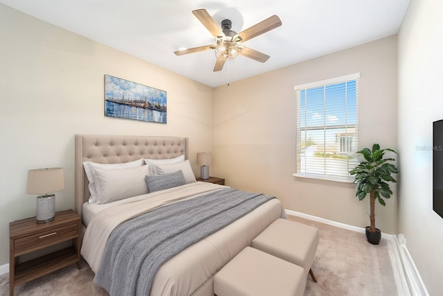 bedroom with ceiling fan and light colored carpet