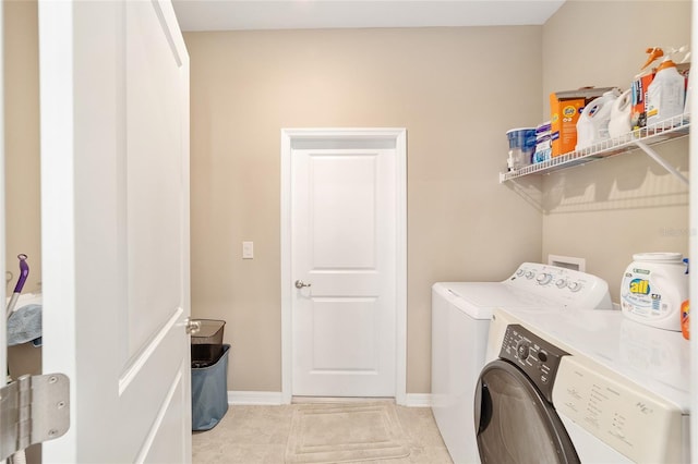 8731 SW 76th Street Rd, Ocala, FL 34481 - laundry area featuring washing machine and dryer, baseboards, and light tile patterned flooring