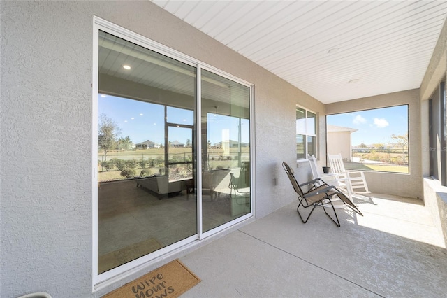 8731 SW 76th Street Rd, Ocala, FL 34481 - sunroom featuring a textured wall and concrete flooring