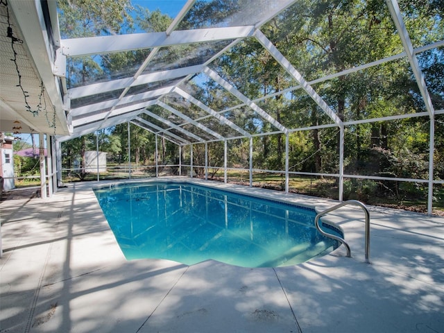 view of swimming pool with a lanai and a patio