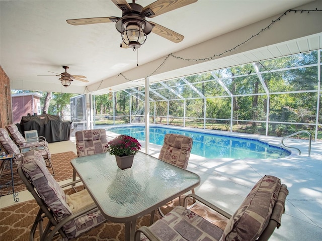 view of pool featuring area for grilling, glass enclosure, and a patio area