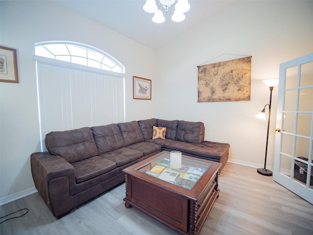 living room featuring an inviting chandelier and light hardwood / wood-style flooring