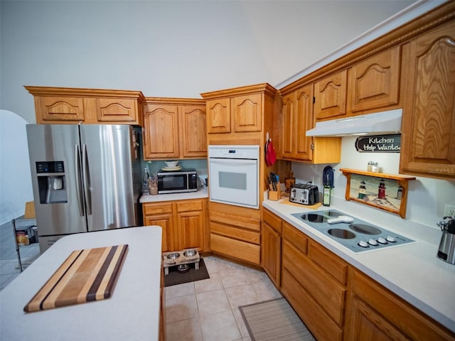 kitchen with appliances with stainless steel finishes and light tile patterned flooring