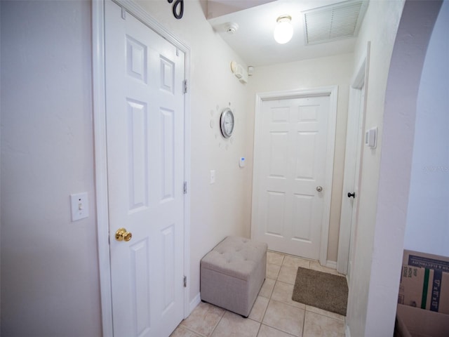 corridor with light tile patterned flooring