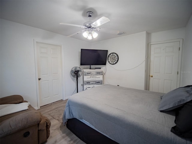 bedroom with light hardwood / wood-style flooring and ceiling fan