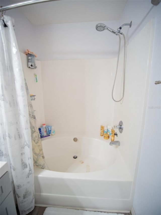 bathroom featuring shower / bath combination with curtain and vanity