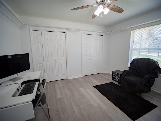 home office featuring ceiling fan and light hardwood / wood-style floors