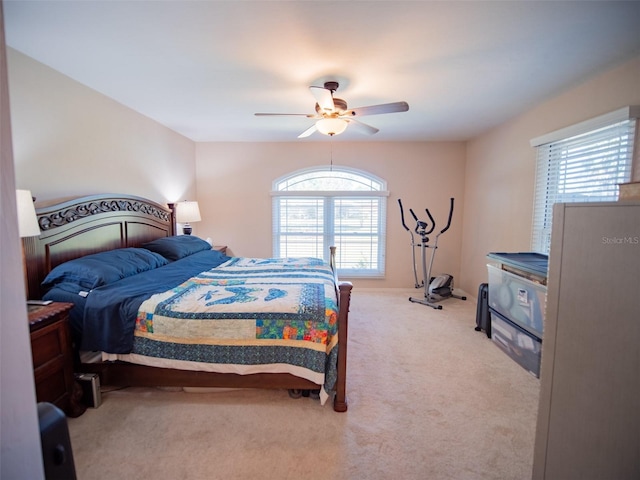 bedroom featuring carpet, ceiling fan, and multiple windows