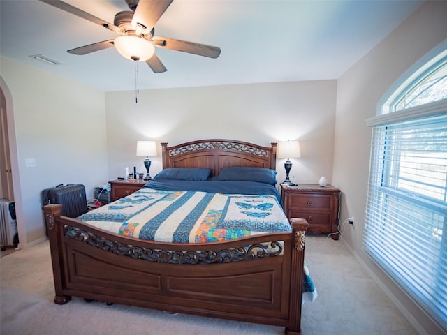 bedroom featuring radiator, light colored carpet, and ceiling fan