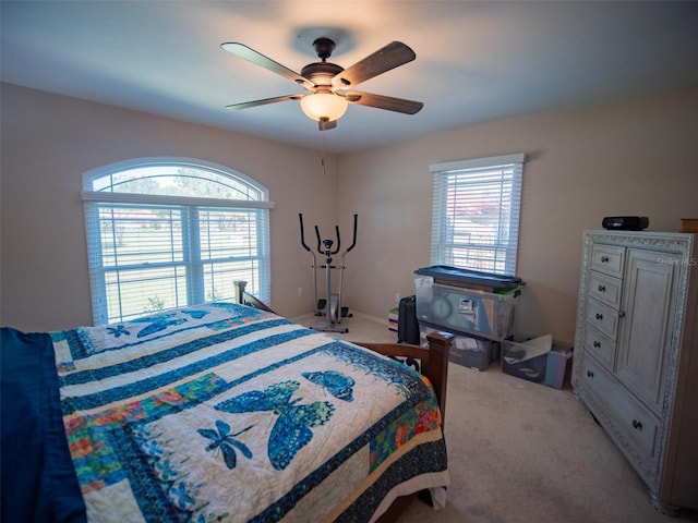 bedroom featuring light colored carpet and ceiling fan