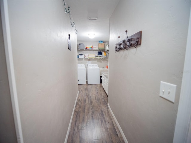 corridor with washing machine and dryer and wood-type flooring