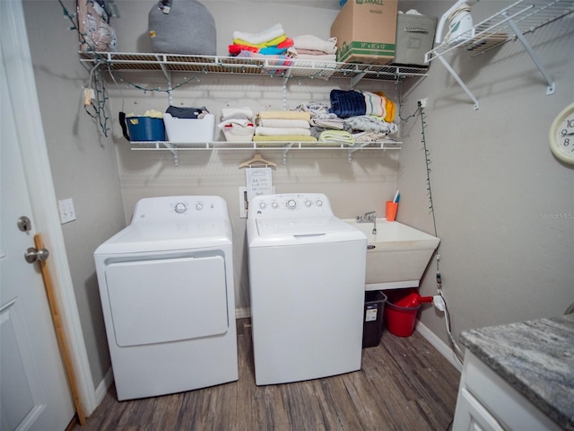 washroom with dark hardwood / wood-style flooring and washer and dryer