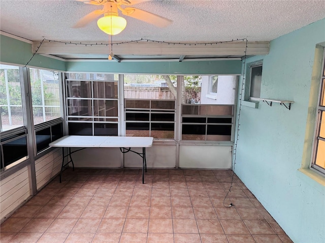 unfurnished sunroom with ceiling fan and a healthy amount of sunlight