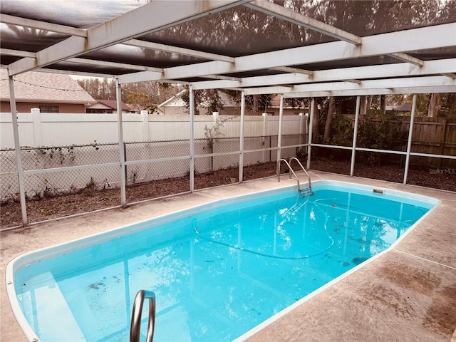 view of swimming pool with glass enclosure