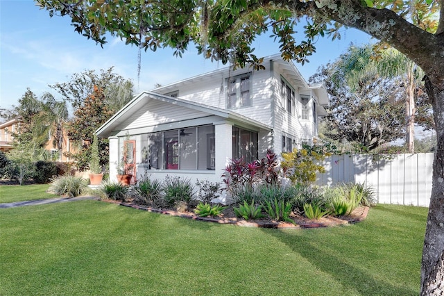 exterior space with a sunroom and a front yard