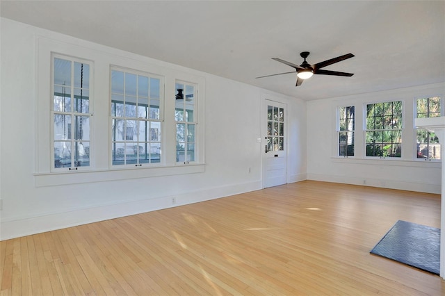 spare room with ceiling fan and light wood-type flooring