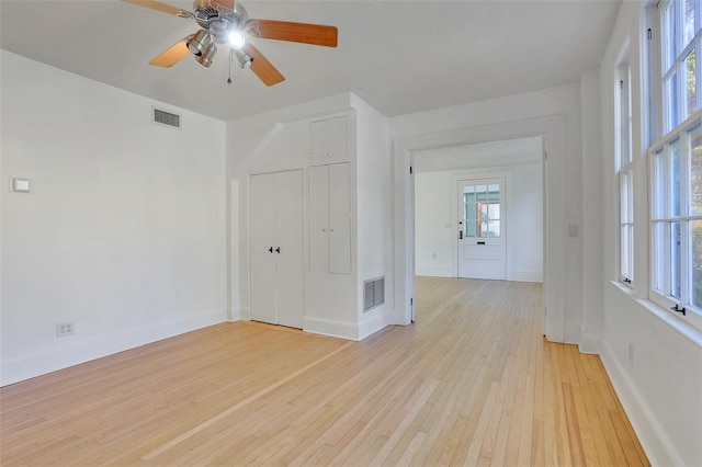 spare room featuring light hardwood / wood-style flooring and ceiling fan