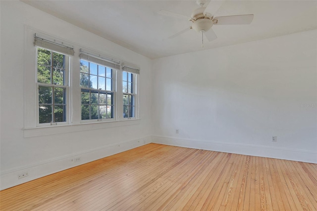 spare room featuring light wood-type flooring and ceiling fan