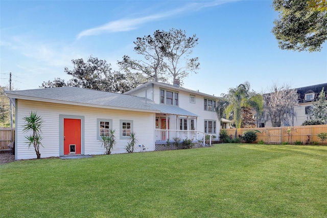 rear view of property with a yard and a deck