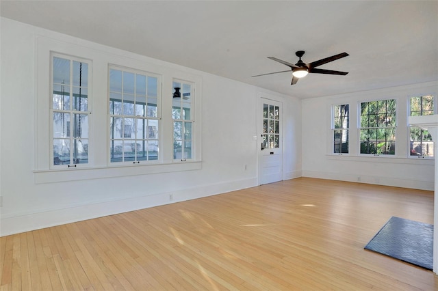 704 NE 4th St, Gainesville, FL 32601 - unfurnished room with wood-type flooring, a ceiling fan, and baseboards