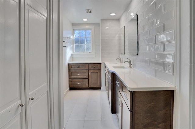704 NE 4th St, Gainesville, FL 32601 - bathroom featuring vanity, tile patterned floors, tasteful backsplash, and recessed lighting