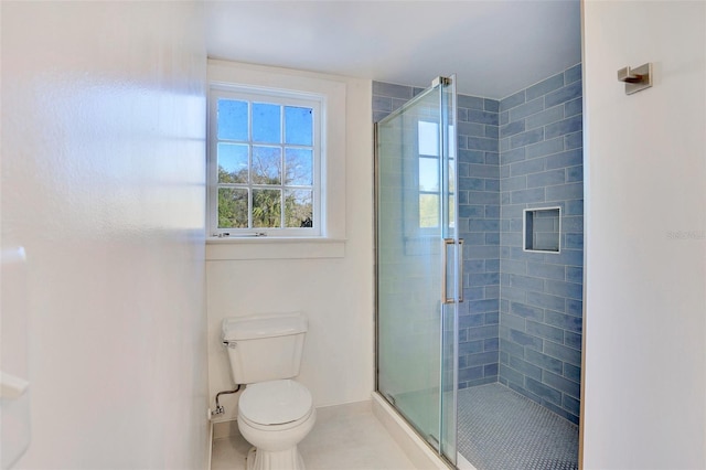 704 NE 4th St, Gainesville, FL 32601 - bathroom featuring toilet, a shower stall, tile patterned floors, and baseboards